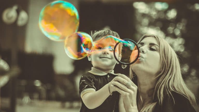 Mother and son blowing bubbles